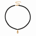 Adele Hamsa Beaded Necklace with black beads and gold tone Hamsa charm.