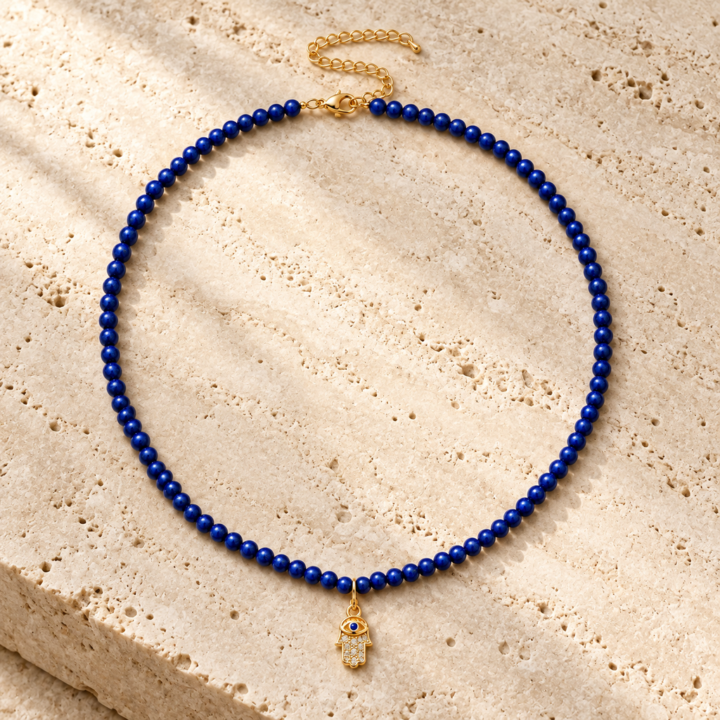 Adele Hamsa Beaded Necklace in Lapis on textured stone.