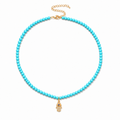 Adele Hamsa Beaded Necklace in Turquoise with gold tone Hamsa charm.