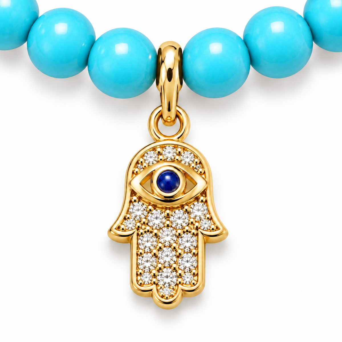 Close-up of gold tone Hamsa charm and turquoise beads.