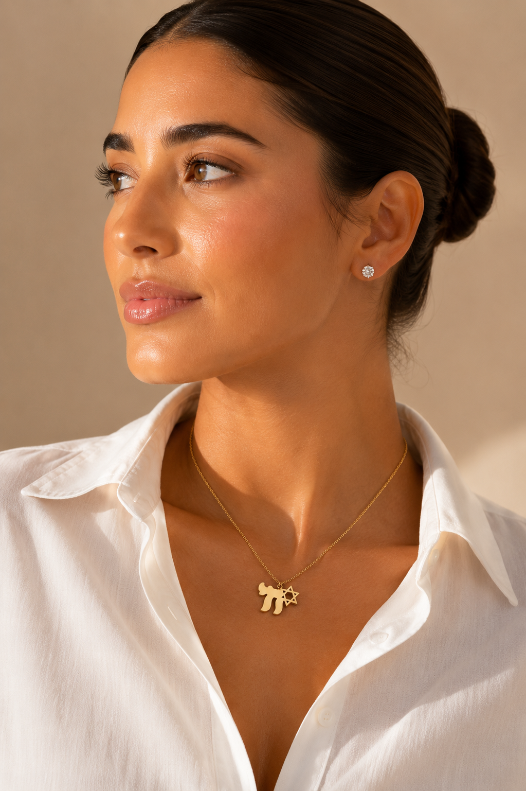 Model wearing the gold tone Am Yisrael Chai necklace.