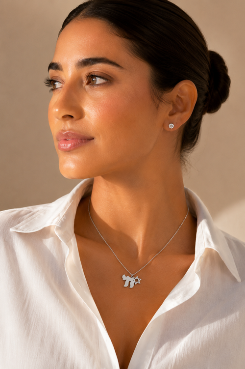 Model wearing the silver tone Am Yisrael Chai necklace.