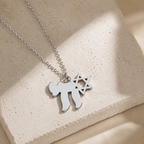 Silver tone Am Yisrael Chai necklace styled on a neutral stone surface.