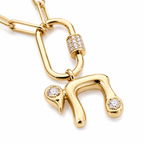 Close-up of the gold tone bubble-style Chai pendant and elongated pavé connector.