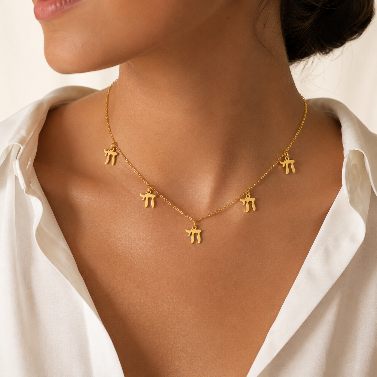Model wearing the gold tone “Chai on Life” Choker Necklace.