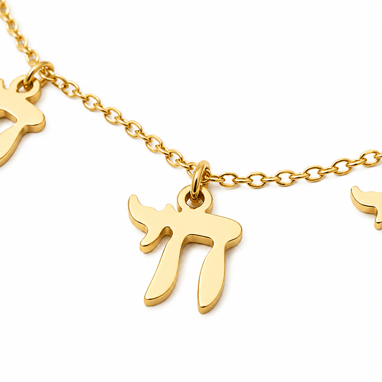 Close-up of the gold tone “Chai on Life” Choker Necklace with dangling Chai charms.