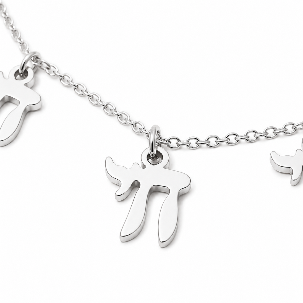 Close-up of the silver tone “Chai on Life” Choker Necklace with dangling Chai charms.