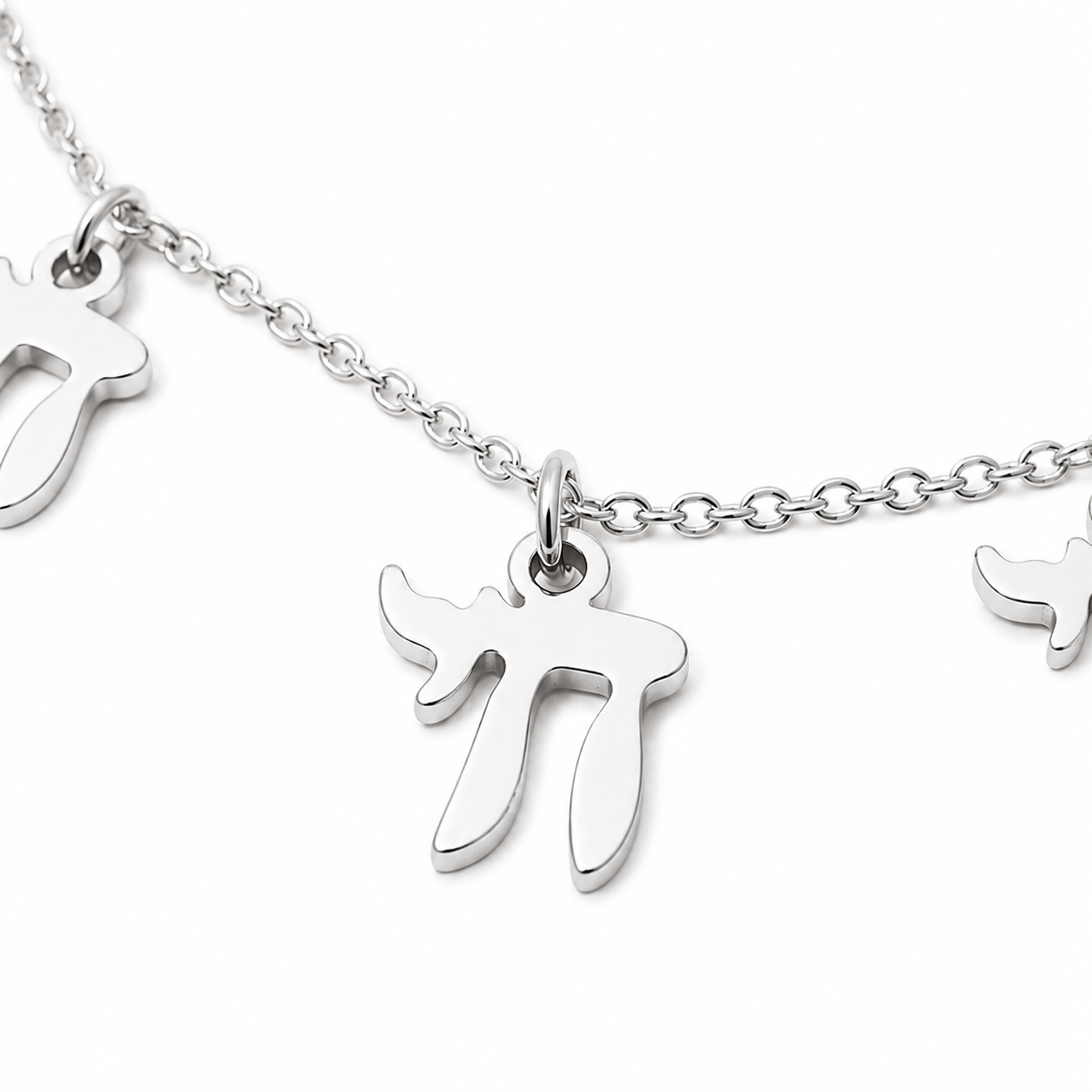 Close-up of the silver tone “Chai on Life” Choker Necklace with dangling Chai charms.
