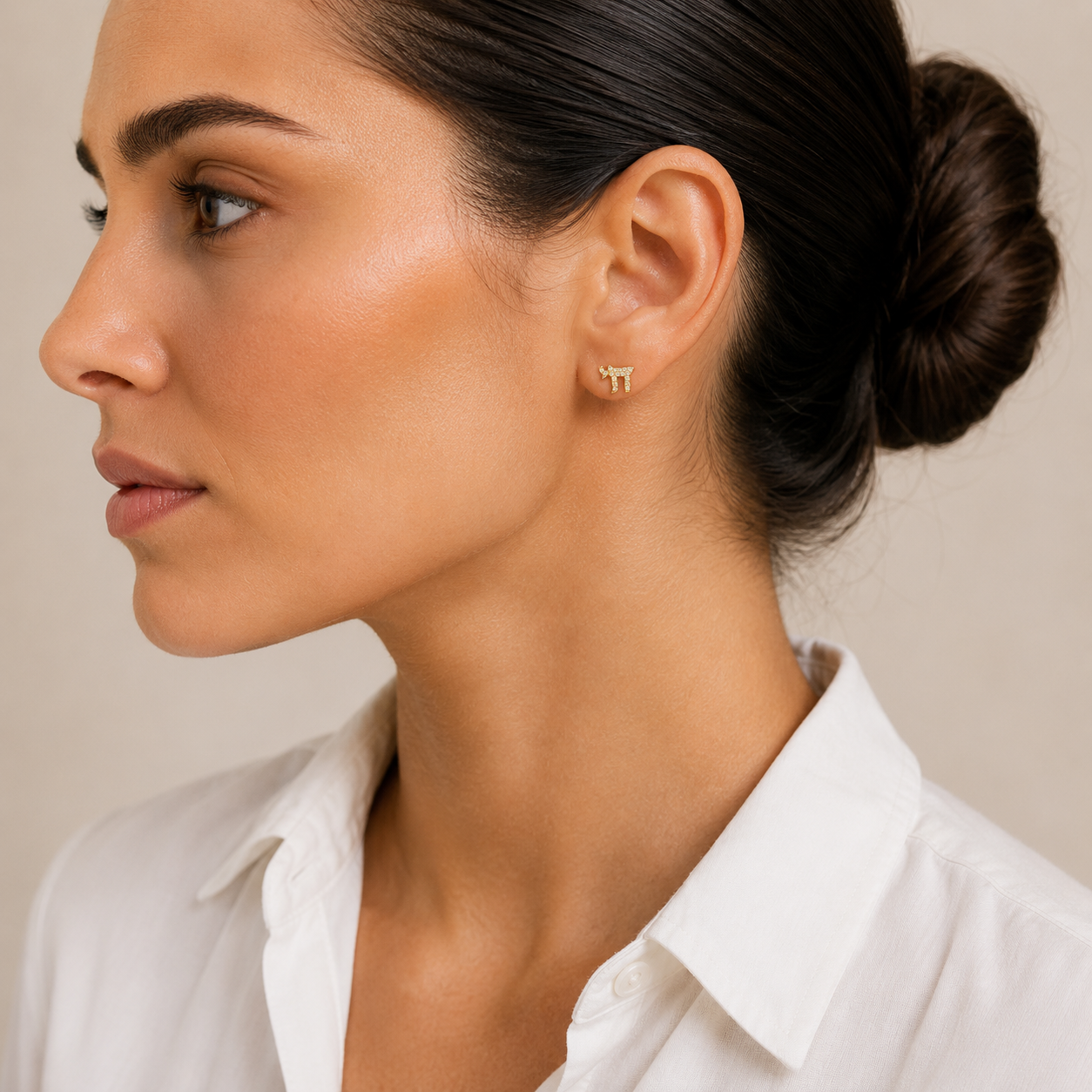 Model wearing the gold tone Chai Pavé Stud Earrings.