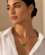 Model wearing the gold tone Perlée Chai Necklace in green.