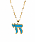Gold tone Perlée Chai Necklace featuring a vibrant turquoise Chai pendant on a white background.