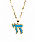 Gold tone Perlée Chai Necklace featuring a vibrant turquoise Chai pendant on a white background.