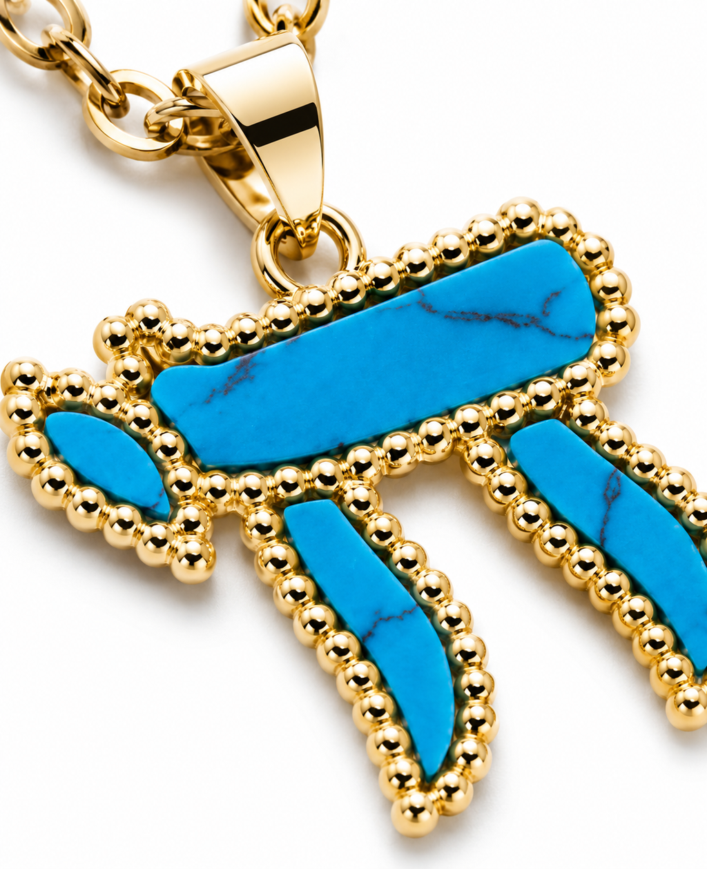Close-up of the turquoise Chai pendant with gold tone detailing.