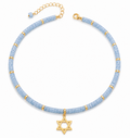 Blue quartz Dead Sea Magen David necklace with gold tone Star of David pendant on a white background.