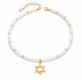 Clear quartz Dead Sea Magen David necklace with gold tone Star of David pendant on a white background.