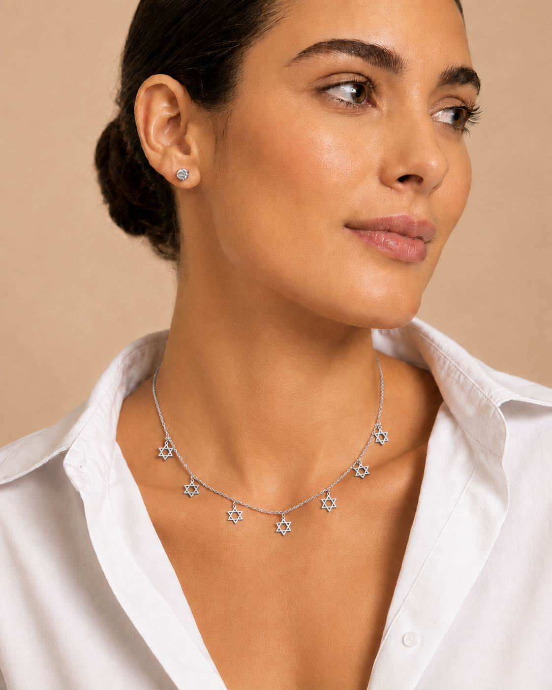 Model wearing the Silver Tone Divine Protection Necklace featuring seven Star of David charms.