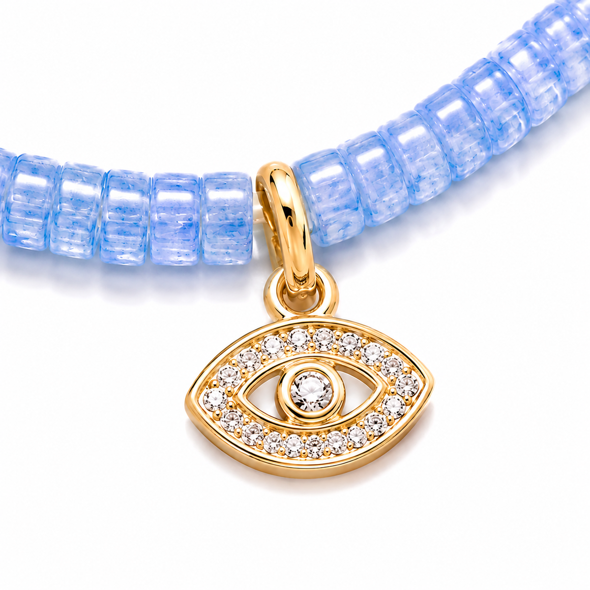 Close-up of the gold tone evil eye charm with pavé cubic zirconia on aquamarine gemstone beads.