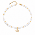 Eden Evil Eye Beaded Choker Necklace with white quartz gemstone beads and gold tone evil eye charm on a white background.