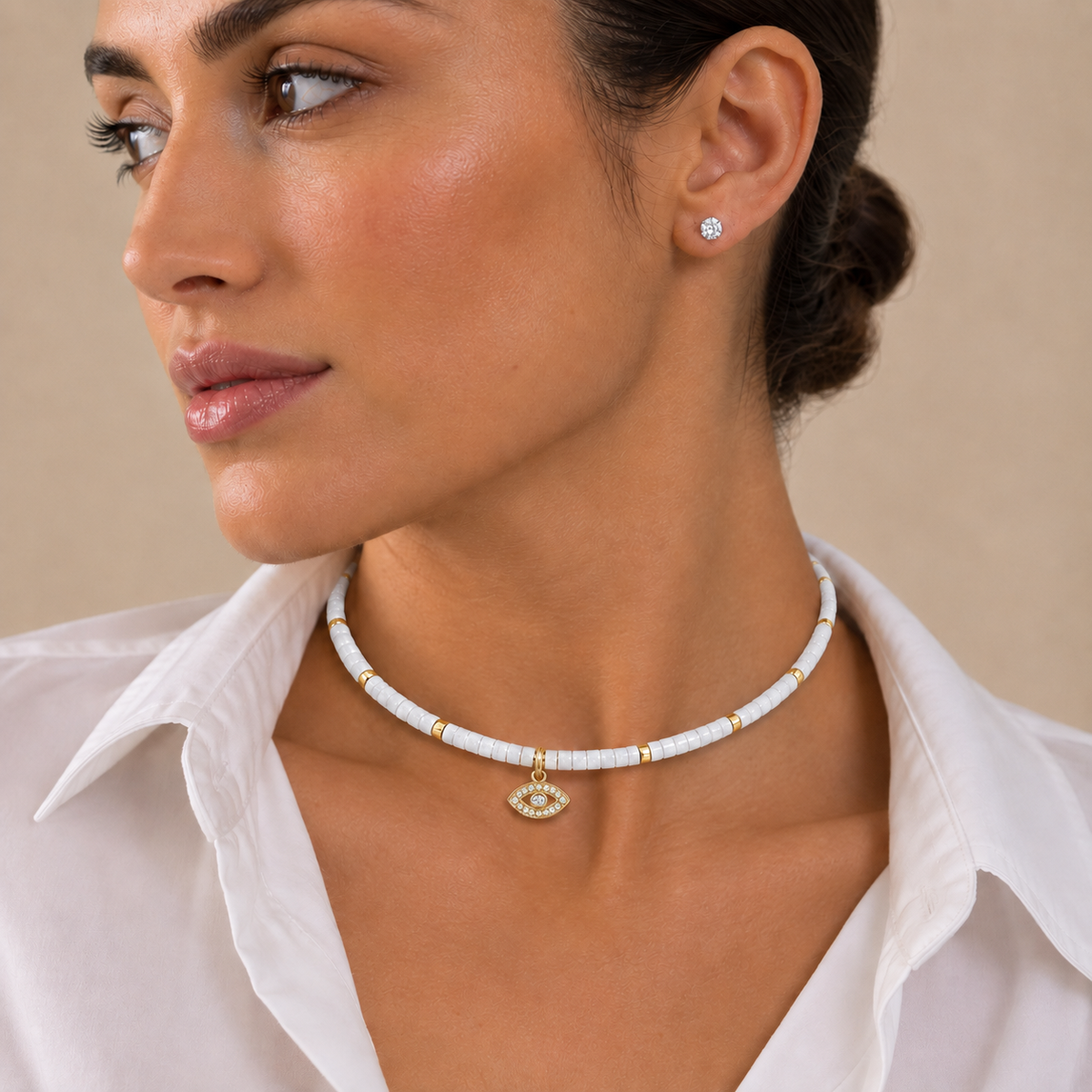 Woman wearing the Eden Evil Eye Beaded Choker Necklace with white quartz gemstone beads.