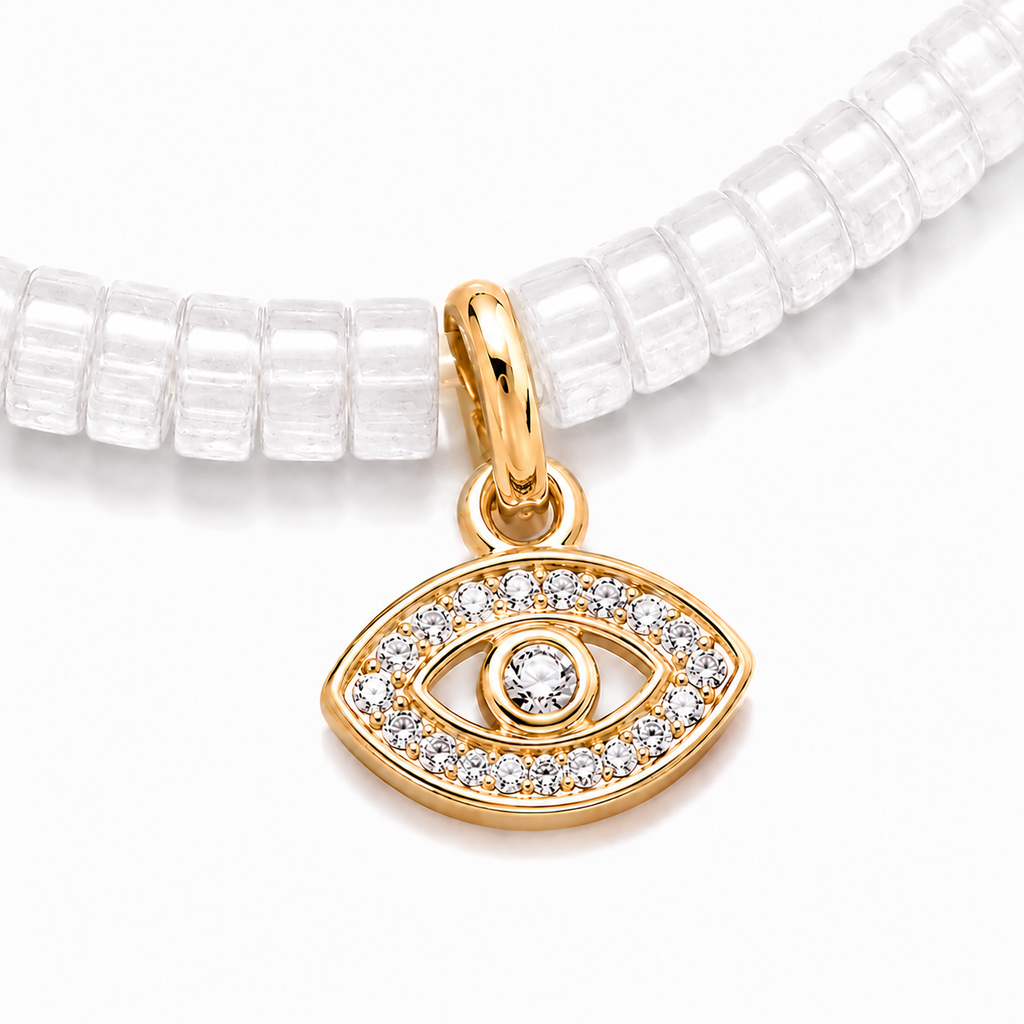 Close-up of the gold tone evil eye charm with pavé cubic zirconia on white quartz gemstone beads.
