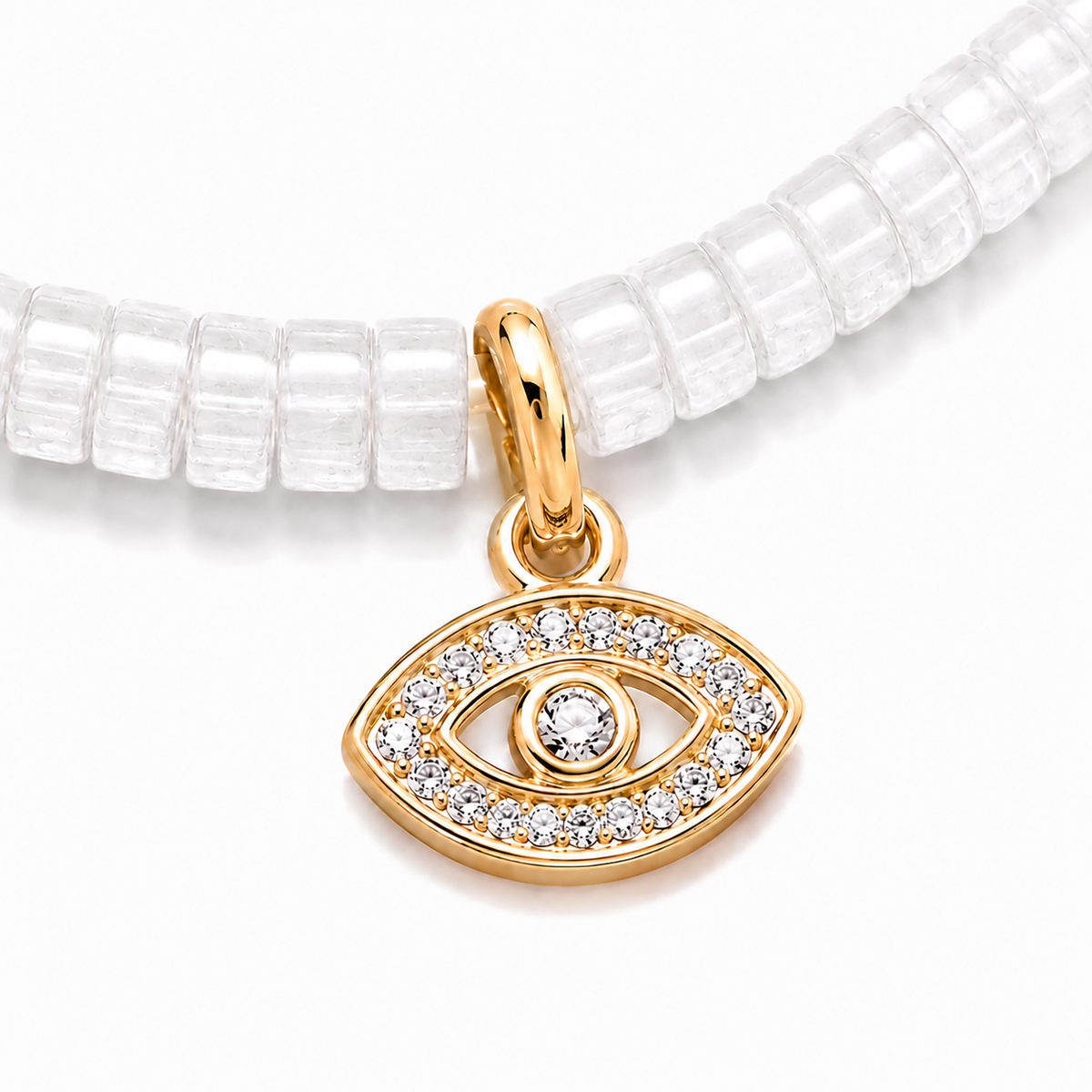 Close-up of the gold tone evil eye charm with pavé cubic zirconia on white quartz gemstone beads.
