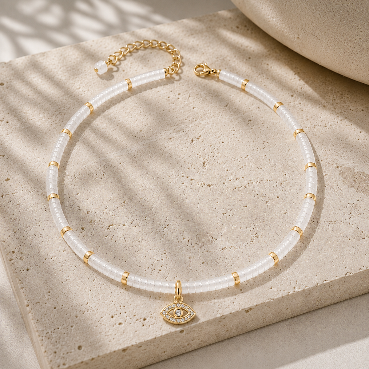Eden Evil Eye Beaded Choker Necklace with white quartz gemstone beads styled on a neutral stone surface.