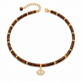 Eden Evil Eye Beaded Choker Necklace with Tiger's Eye gemstone beads and gold tone evil eye charm on a white background.