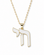Gold tone Chai necklace with white enamel pendant on a white background.
