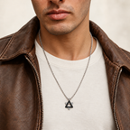 Man wearing the Ezra black Star of David necklace over an ivory T-shirt with a brown leather jacket.