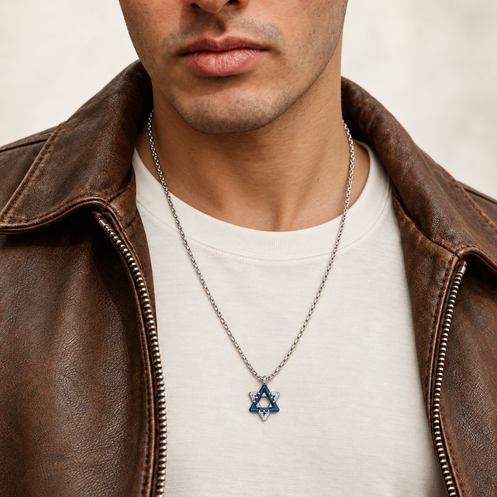Man wearing the Ezra blue Star of David necklace over an ivory T-shirt with a brown leather jacket.
