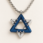 Close-up of the Ezra blue Star of David pendant showing layered triangles and cubic zirconia accents.