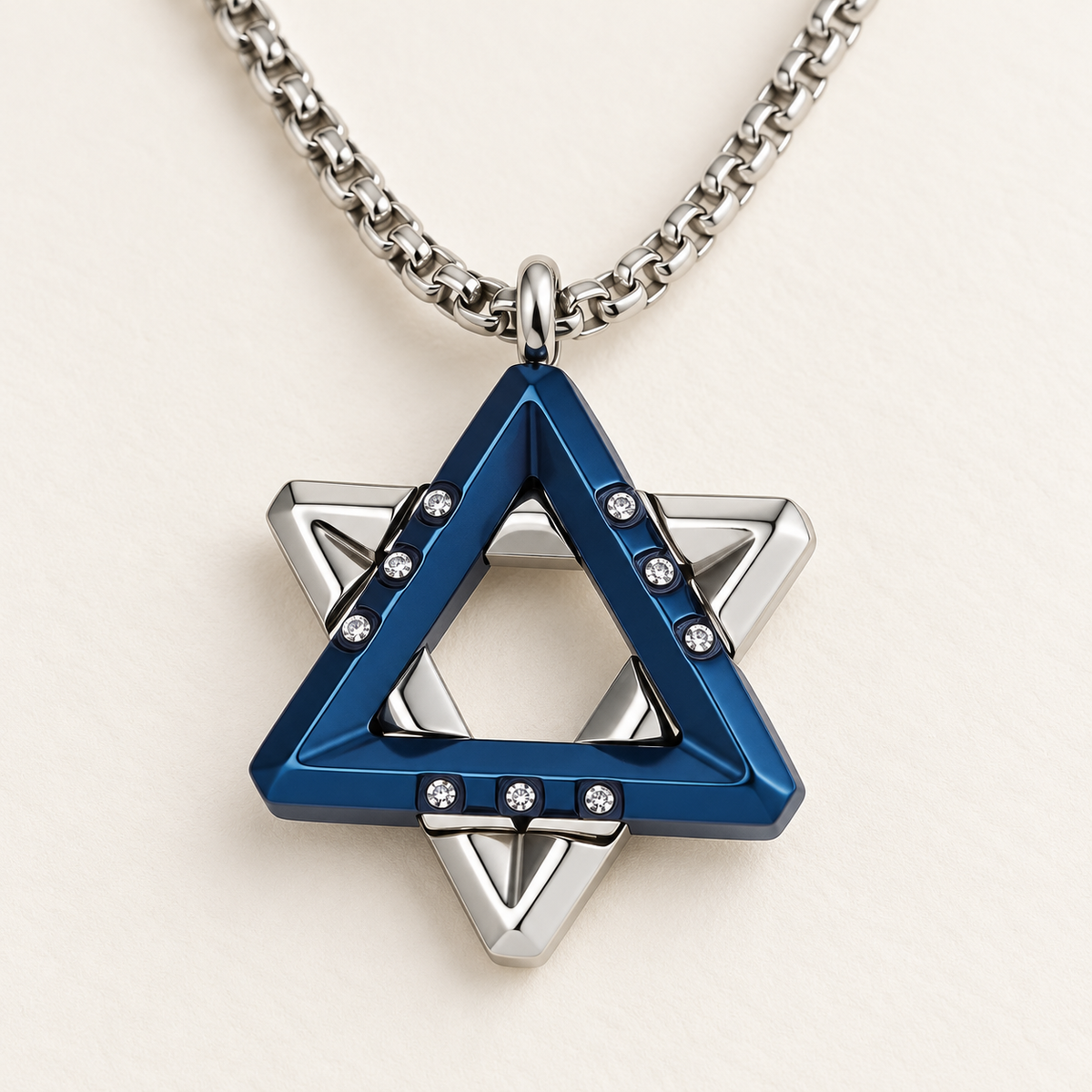 Close-up of the Ezra blue Star of David pendant showing layered triangles and cubic zirconia accents.