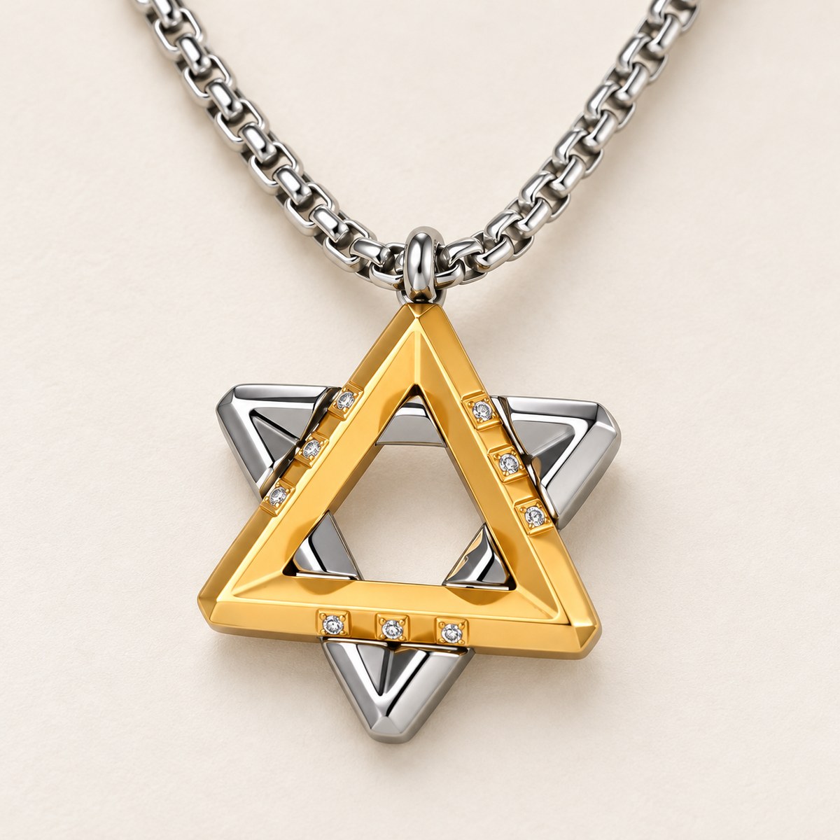 Close-up of the Ezra gold-tone Star of David pendant showing layered triangles and cubic zirconia accents.