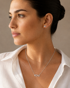 Woman wearing the Haifa Fish Necklace – Silver Tone with a pavé cubic zirconia fish pendant.