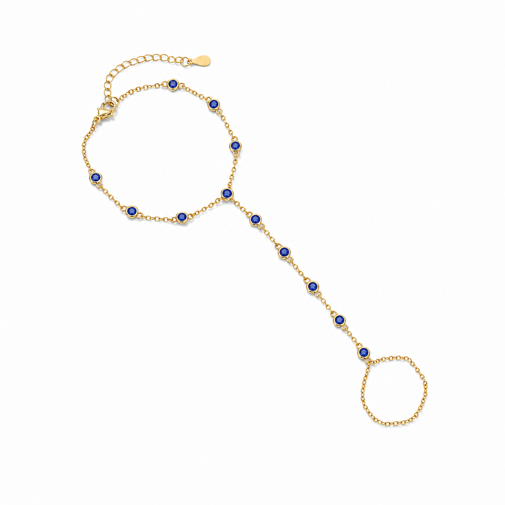 Gold tone Hava CZ Hand Chain with sapphire-colored cubic zirconia on a white background.
