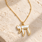 Lev Chai Necklace with mother-of-pearl Chai pendant on neutral stone surface.