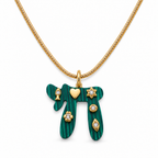 Green Lucky Chai Necklace with gold tone snake chain and symbolic charms on a white background.