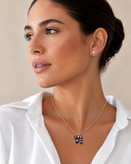 Model wearing the navy Lucky Chai Necklace with a white blouse.