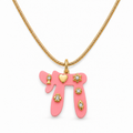 Pink Lucky Chai Necklace with gold tone snake chain and symbolic charms on a white background.