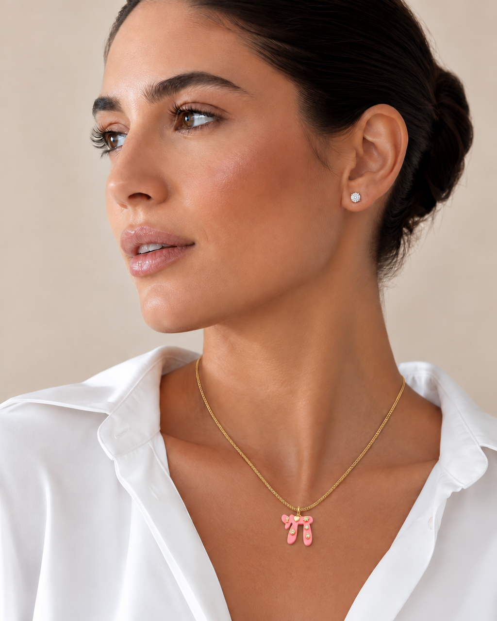 Model wearing the pink Lucky Chai Necklace with a white blouse.