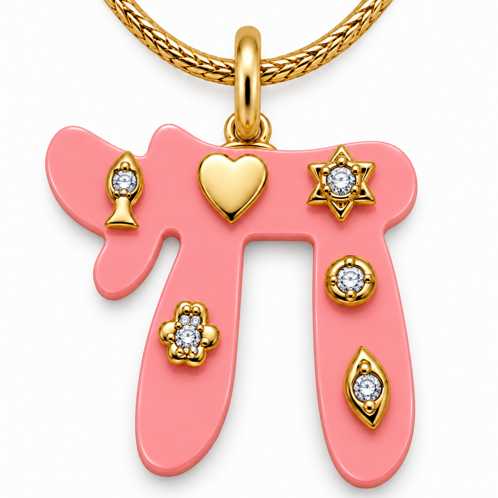 Close-up of the pink Chai pendant with a heart, fish, Star of David, Hamsa, evil eye, and round stone accent.