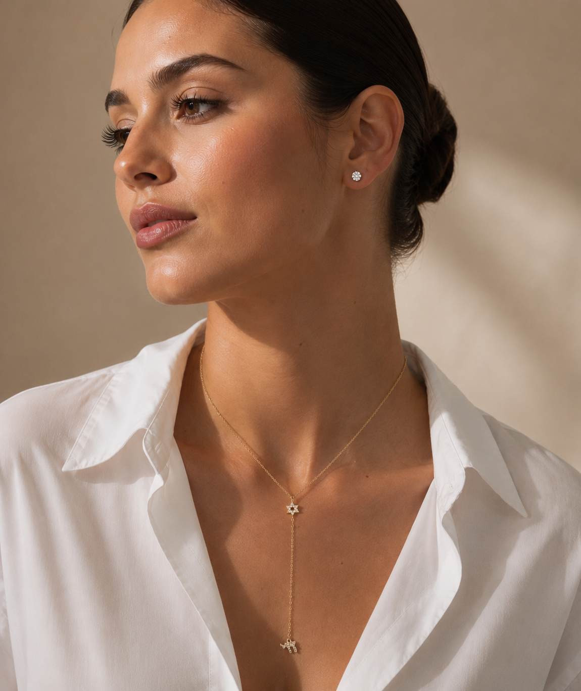 Model wearing the gold tone Magen David Lariat Necklace.