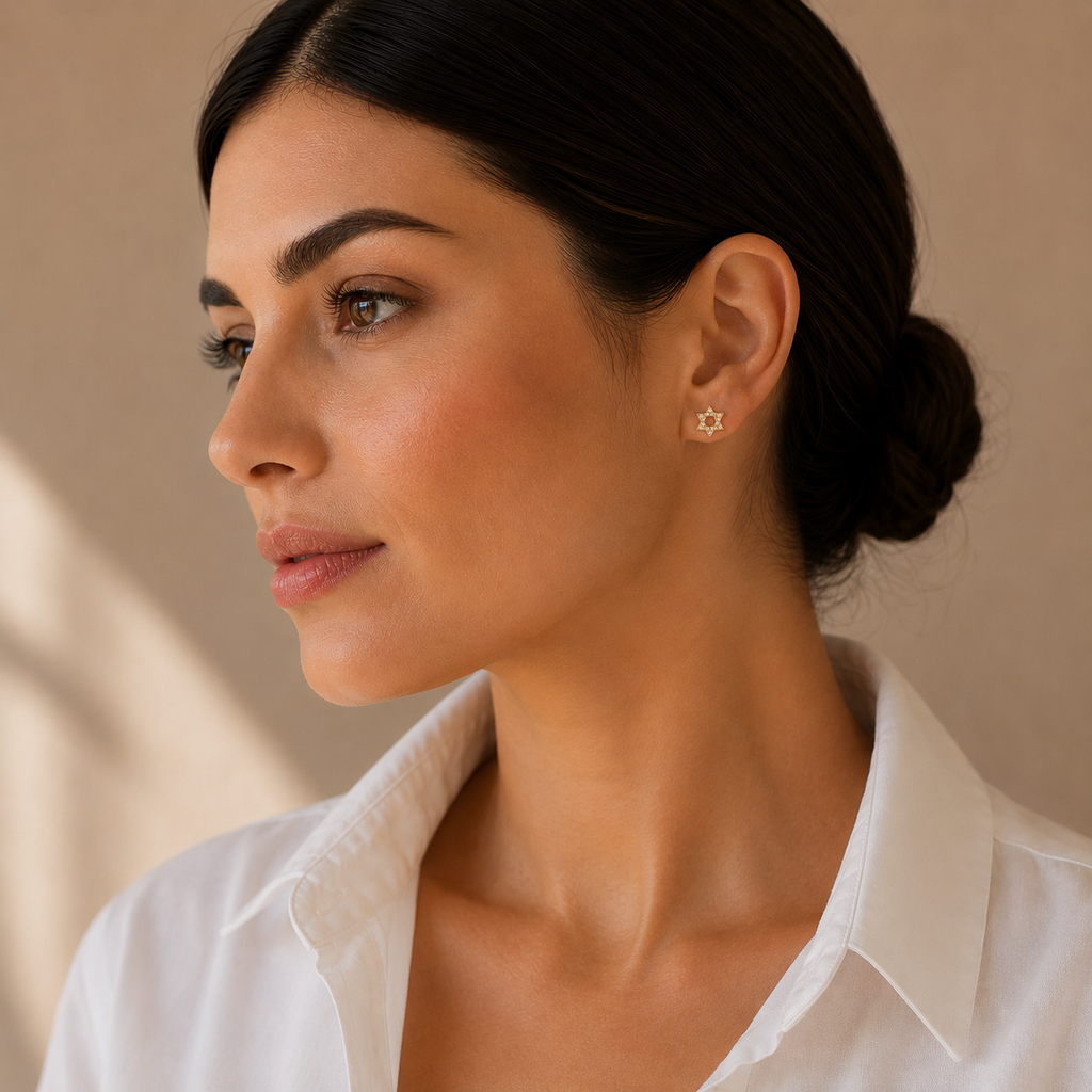 Model wearing the gold tone Magen David pavé stud earrings.
