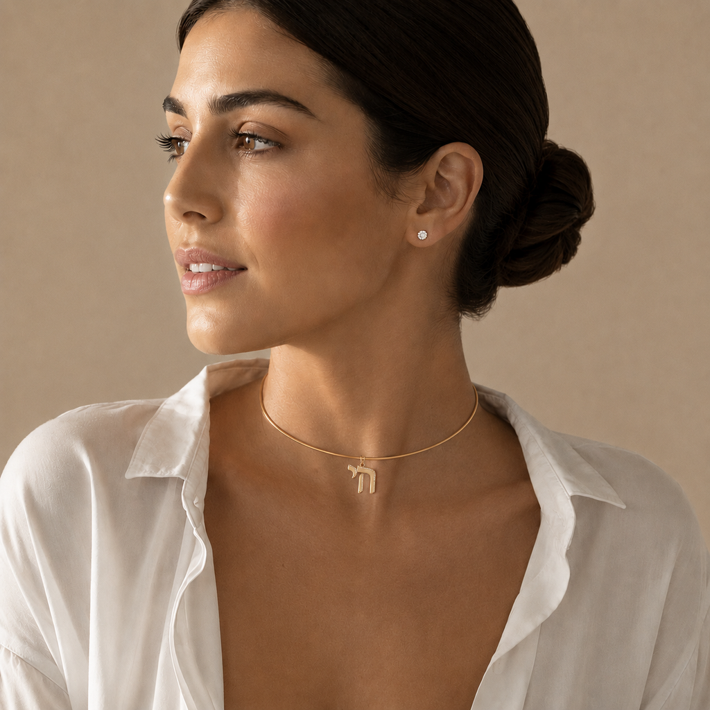 Model wearing the gold tone Outline Pavé Chai choker.