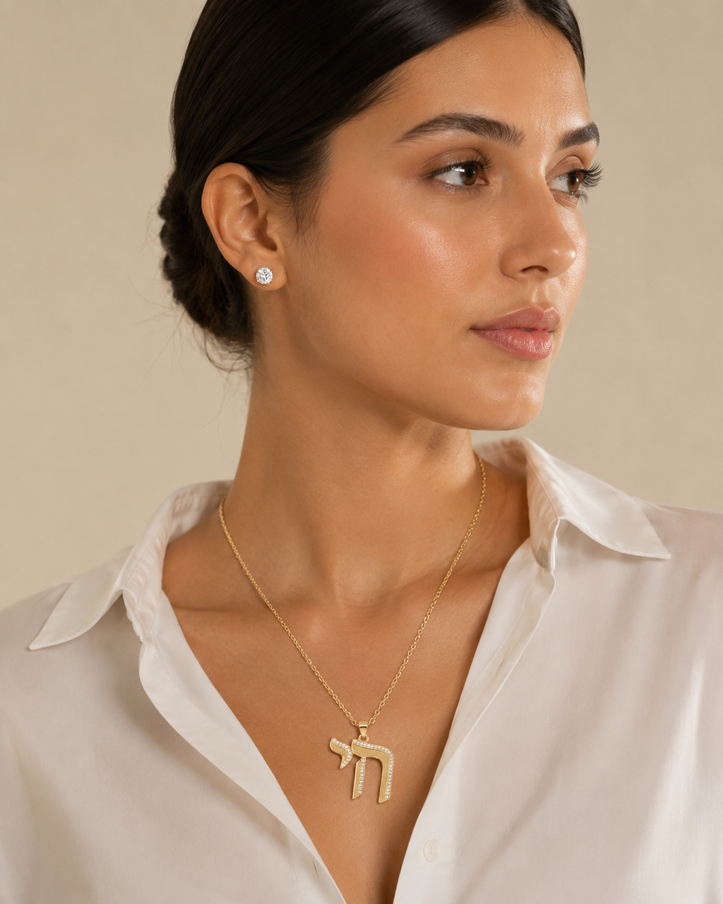 Model wearing the gold tone Outline Pavé Chai Necklace.
