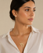Model wearing the gold tone Outline Pavé Chai Necklace.