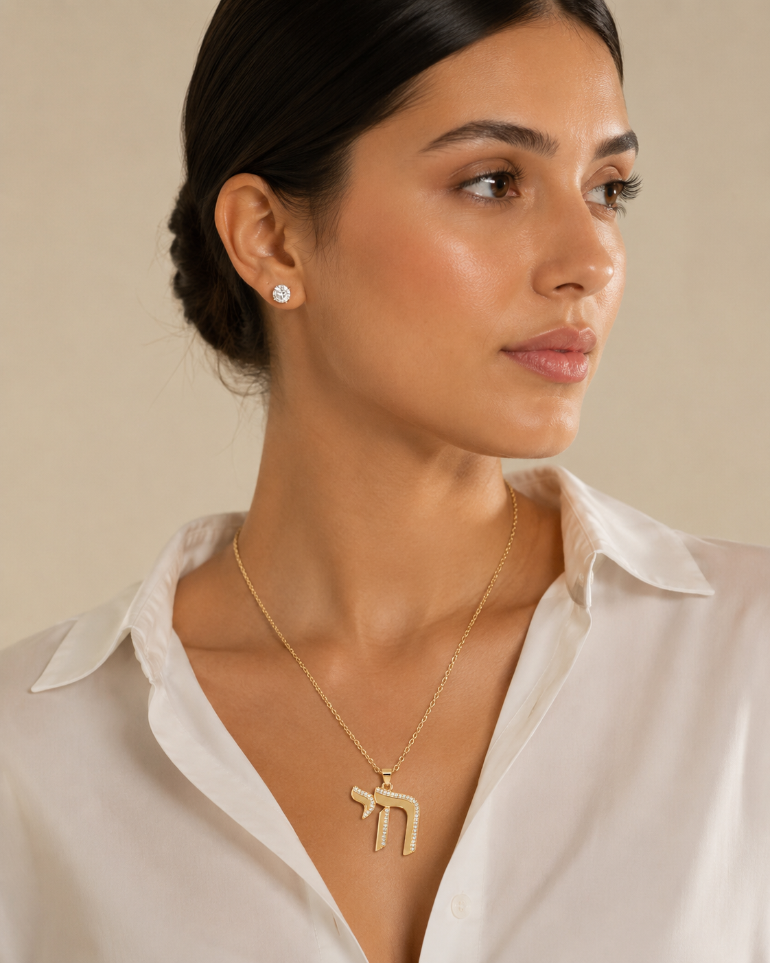 Model wearing the gold tone Outline Pavé Chai Necklace.