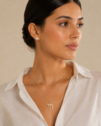 Model wearing the gold tone Outline Pavé Chai Necklace.