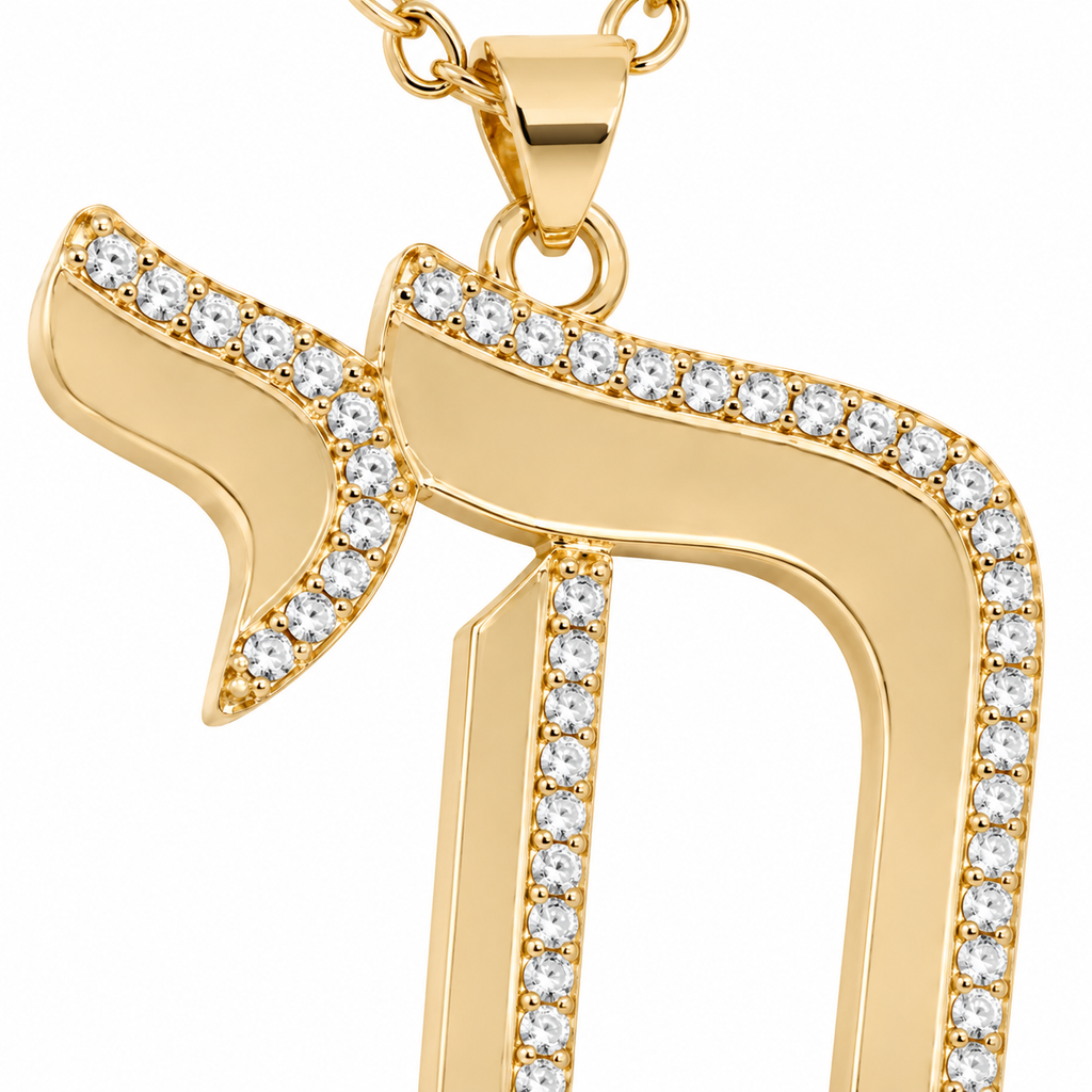 Close-up of the gold tone Outline Pavé Chai pendant with pavé-set stones.