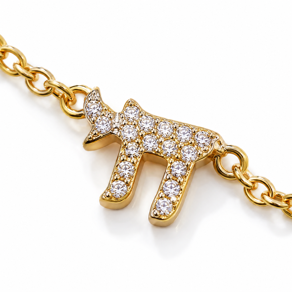 Close-up of the pavé cubic zirconia Chai charm on the Gold Tone Pavé Trio Bracelet.
